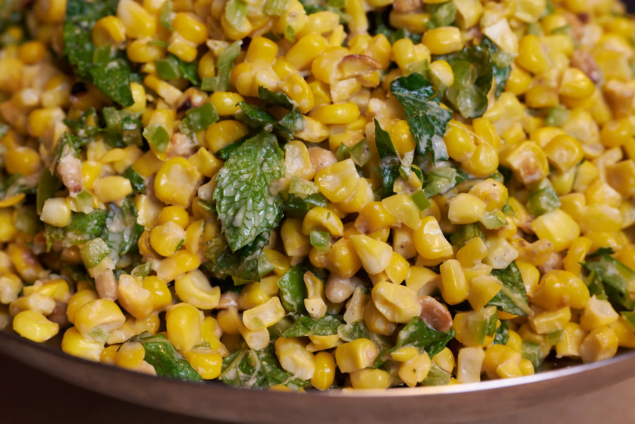 Sweet corn salad with pine nut dressing, mint, and peppers