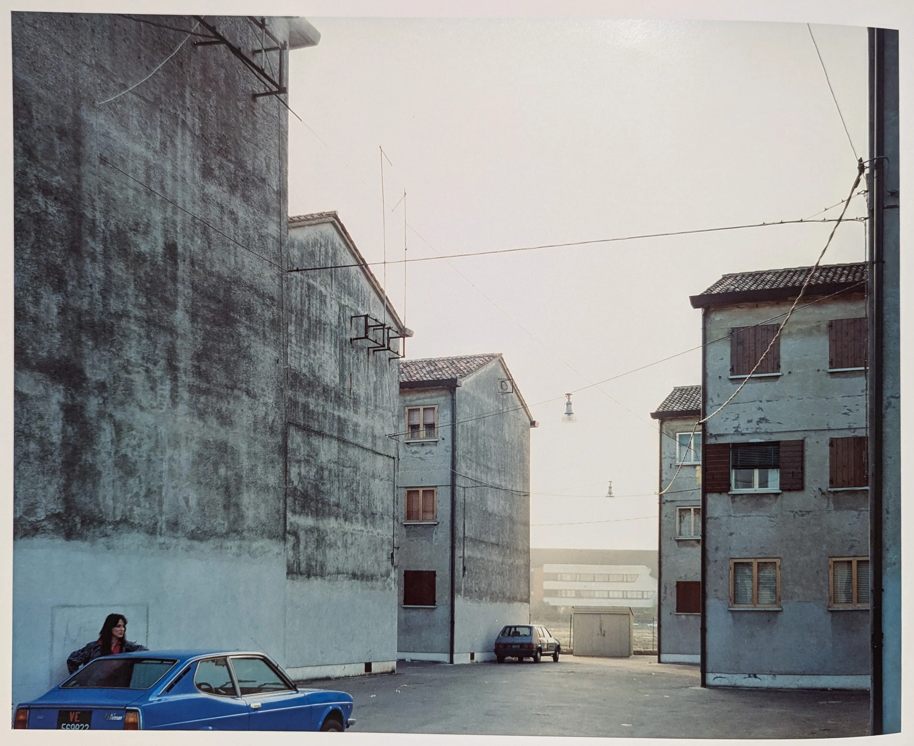 Guido Guidi's photo of a person leaning against a car